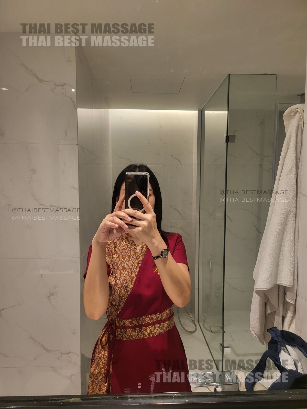 Therapist Khun Preaw setting up for a professional oil massage service in a Bangkok hotel suite.